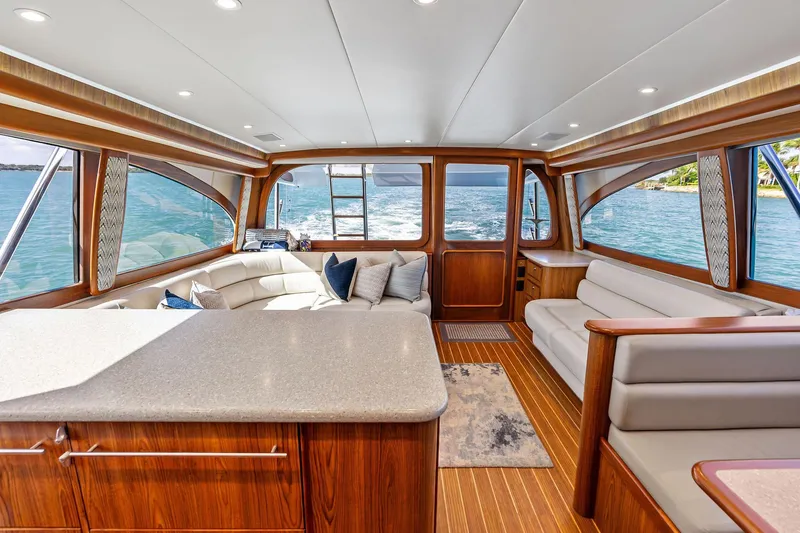 Knot Haulin Yacht Photos Pics Luxurious interior of a 2017 Spencer Convertible yacht with elegant wood finishes and plush seating.