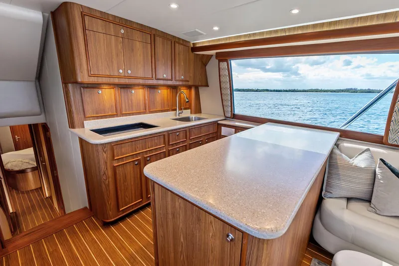 Knot Haulin Yacht Photos Pics Luxurious 2017 Spencer Convertible yacht interior with wooden cabinetry and ocean view.