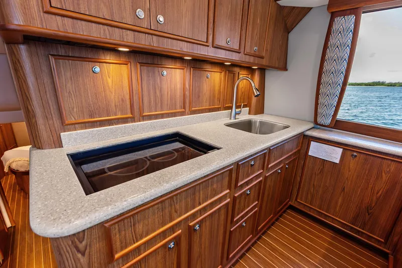Knot Haulin Yacht Photos Pics Luxurious 2017 Spencer Convertible yacht kitchen with wood cabinetry and ocean view.