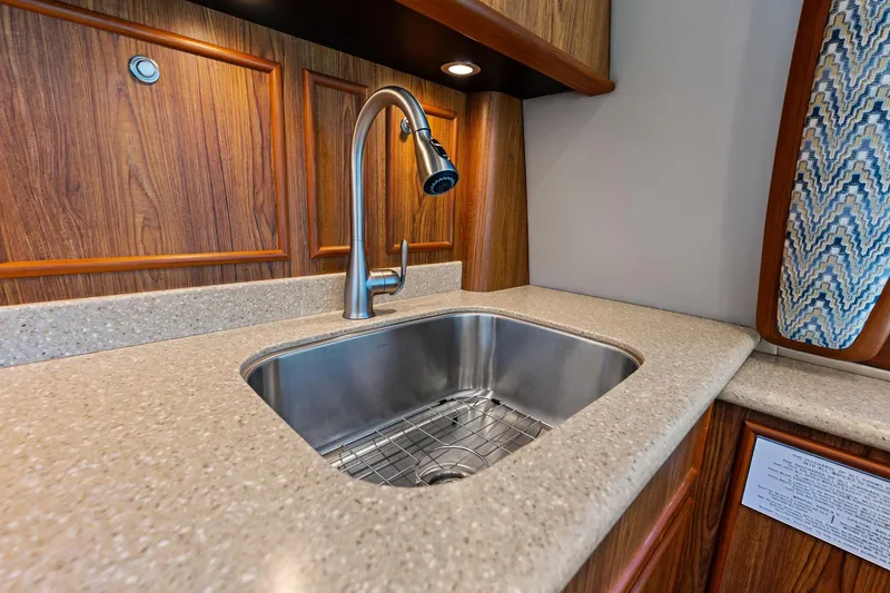 Knot Haulin Yacht Photos Pics Luxurious kitchen sink in 2017 Spencer Convertible yacht with wood paneling and modern faucet.