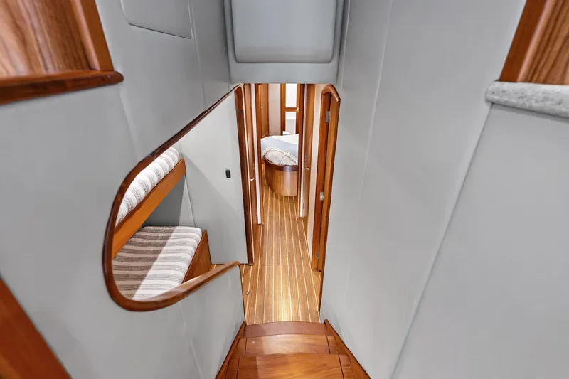 Knot Haulin Yacht Photos Pics Interior of 2017 Spencer Convertible yacht with wooden flooring and cozy sleeping area.
