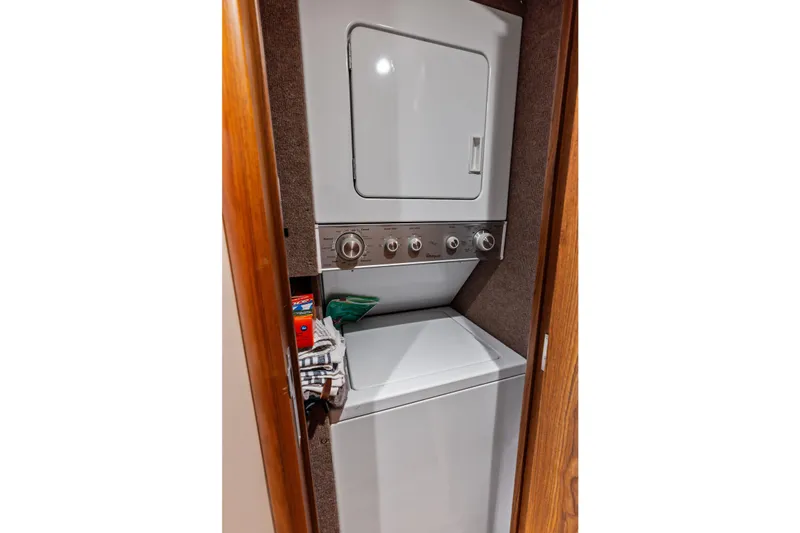 Knot Haulin Yacht Photos Pics Stacked washer and dryer in a compact wooden closet, Spencer Convertible 2017.