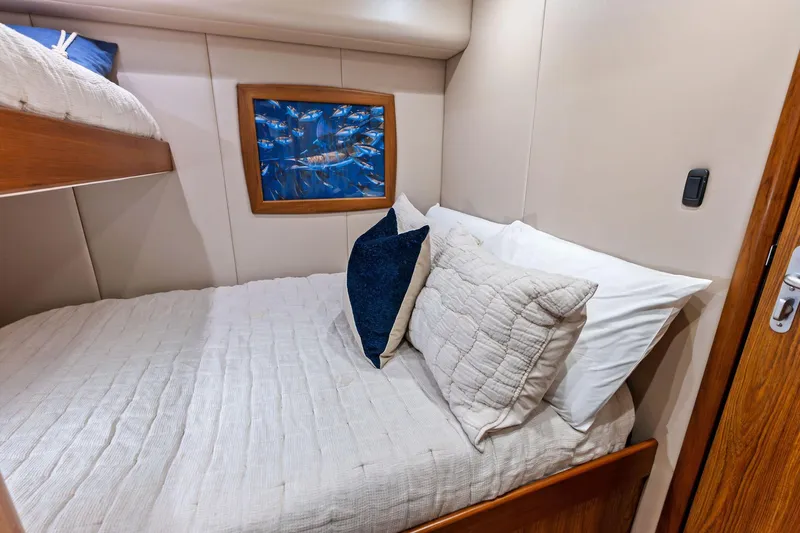 Knot Haulin Yacht Photos Pics Cozy cabin interior of 2017 Spencer Convertible with bed and ocean-themed artwork.