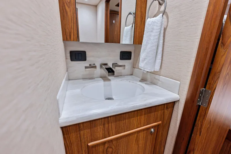 Knot Haulin Yacht Photos Pics 2017 Spencer Convertible bathroom with modern sink, wooden cabinetry, and towel ring.