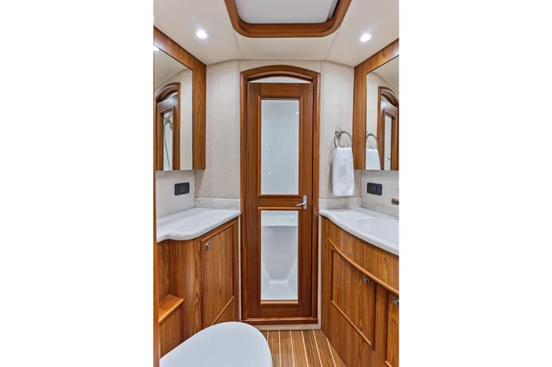 Knot Haulin Yacht Photos Pics Luxurious 2017 Spencer Convertible bathroom with wooden cabinetry and modern fixtures.