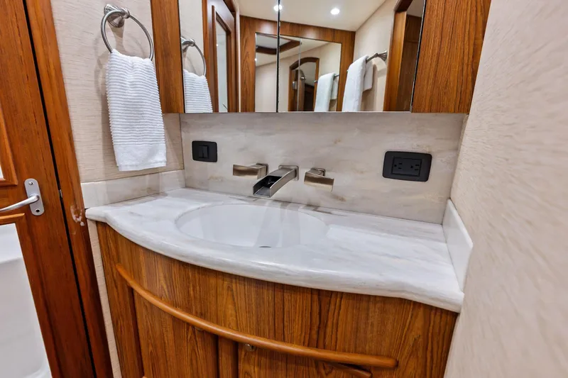 Knot Haulin Yacht Photos Pics Luxurious bathroom vanity in 2017 Spencer Convertible yacht, featuring wood accents and modern fixtures.