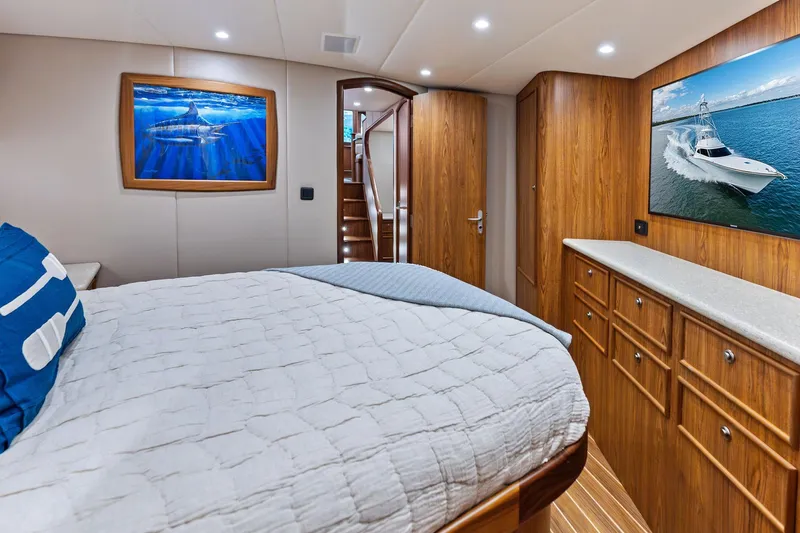 Knot Haulin Yacht Photos Pics Luxurious 2017 Spencer Convertible yacht bedroom with wooden cabinetry and marine-themed artwork.
