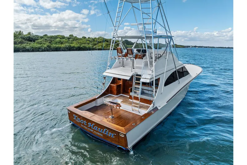 Knot Haulin Yacht Photos Pics 2017 Spencer Convertible yacht on water, featuring a sleek design and spacious deck.