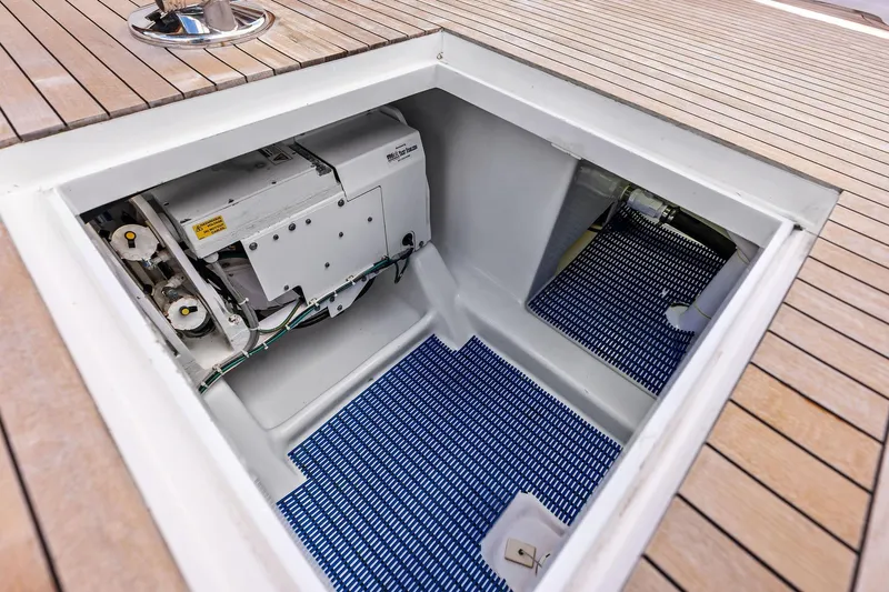 Knot Haulin Yacht Photos Pics Engine compartment of a 2017 Spencer Convertible boat with wooden deck.