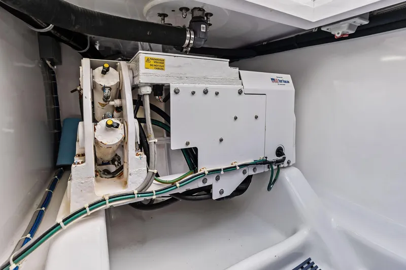Knot Haulin Yacht Photos Pics Engine compartment of a 2017 Spencer Convertible boat, featuring mechanical components and wiring.
