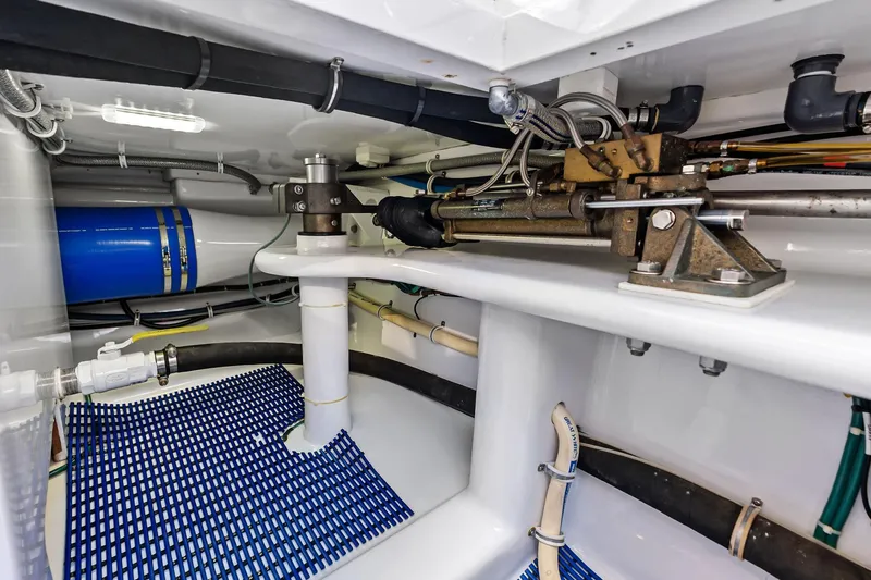 Knot Haulin Yacht Photos Pics 2017 Spencer Convertible yacht engine room with hydraulic systems and blue mat flooring.