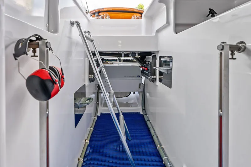 Knot Haulin Yacht Photos Pics Interior view of a 2017 Spencer Convertible boat engine compartment with ladder and equipment.