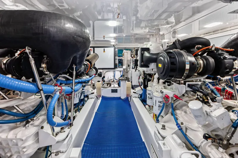 Knot Haulin Yacht Photos Pics Engine room of a 2017 Spencer Convertible yacht, showcasing complex machinery and components.