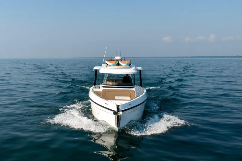  Yacht Photos Pics 2026 Cruisers Yachts 38 VTR navigating calm waters under clear skies.