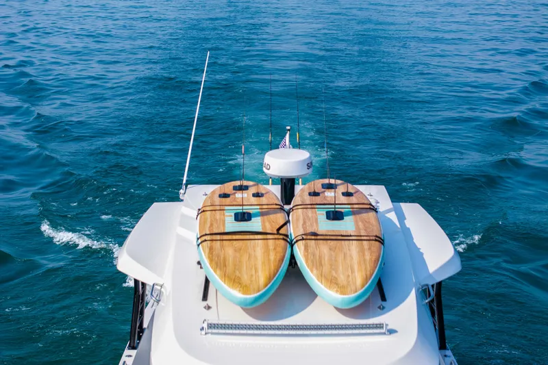  Yacht Photos Pics 2026 Cruisers Yachts 38 VTR with paddleboards on deck, cruising on open water.