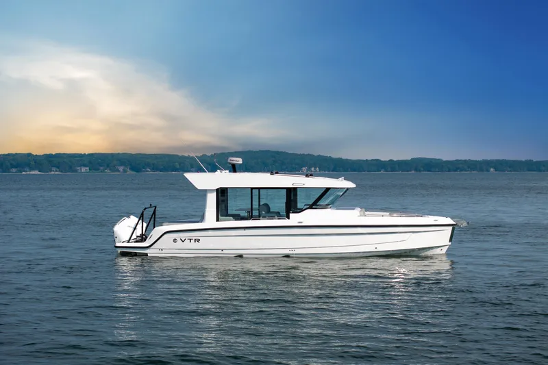  Yacht Photos Pics 2026 Cruisers Yachts 38 VTR on serene lake under blue sky.