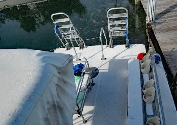  Yacht Photos Pics Newton 46 Dive Special boat, 2004 model, docked with diving ladders and equipment.