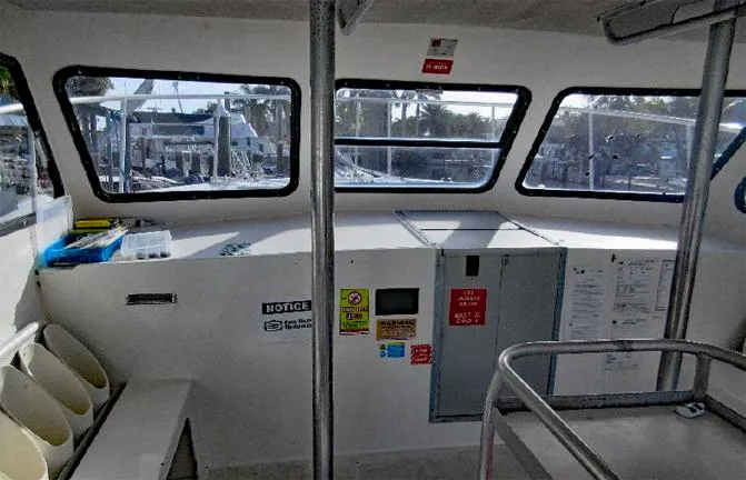  Yacht Photos Pics Interior of a 2004 Newton 46 Dive Special boat, featuring windows and safety notices.