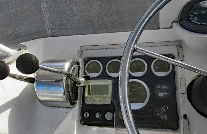 Yacht Photos Pics Control panel of a 2004 Newton 46 Dive Special boat with steering wheel and gauges.