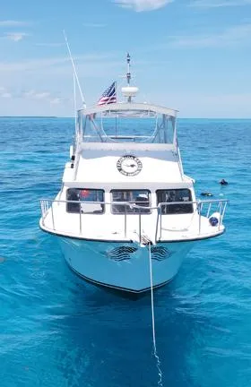  Yacht Photos Pics Newton 46 Dive Special boat, 2004 model, anchored in clear blue ocean waters.