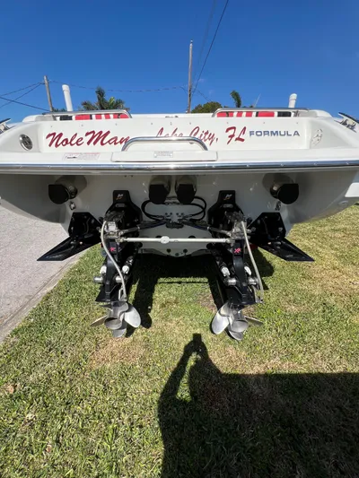  Yacht Photos Pics 2016 Formula 353 FASTech boat rear view, dual propellers, parked on grass under clear blue sky.