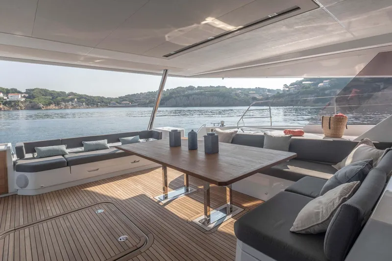  Yacht Photos Pics Luxurious 2026 Fountaine Pajot Samana 59 yacht interior with elegant seating and scenic ocean view.