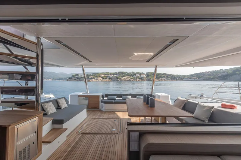  Yacht Photos Pics Luxurious 2026 Fountaine Pajot Samana 59 yacht interior with elegant seating and scenic ocean view.
