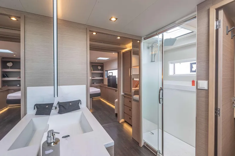  Yacht Photos Pics Luxurious interior of 2026 Fountaine Pajot Samana 59 yacht with modern bathroom and bedroom.