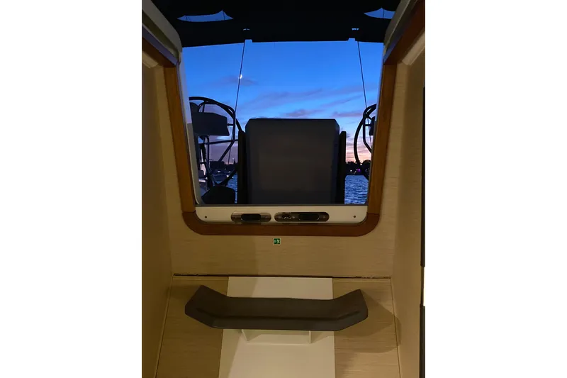 Recovery Room Yacht Photos Pics Interior view of 2019 Jeanneau 51 yacht at sunset, showcasing helm and ocean.