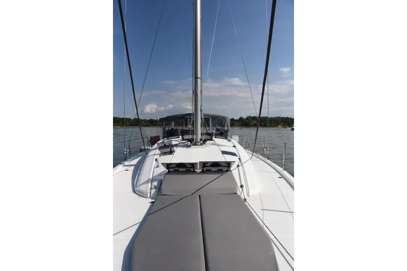 Recovery Room Yacht Photos Pics 2019 Jeanneau 51 sailboat deck view on calm water under blue sky.