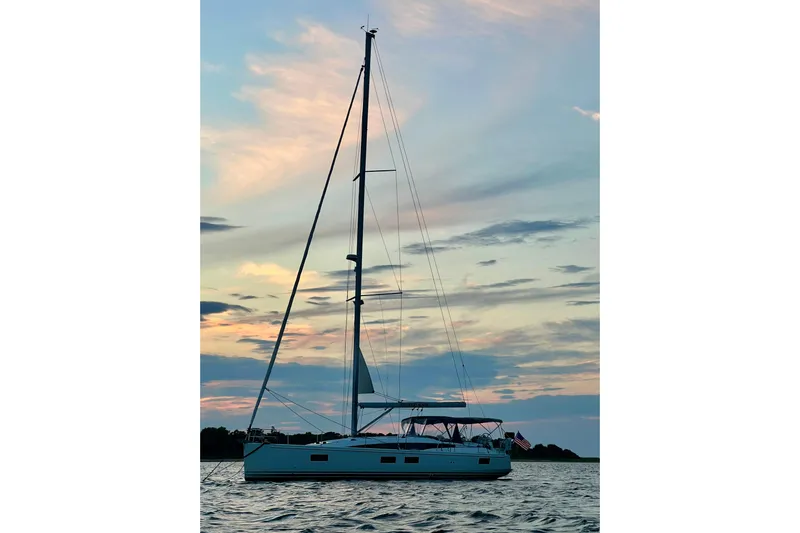 Recovery Room Yacht Photos Pics 2019 Jeanneau 51 sailboat at sunset on calm waters.