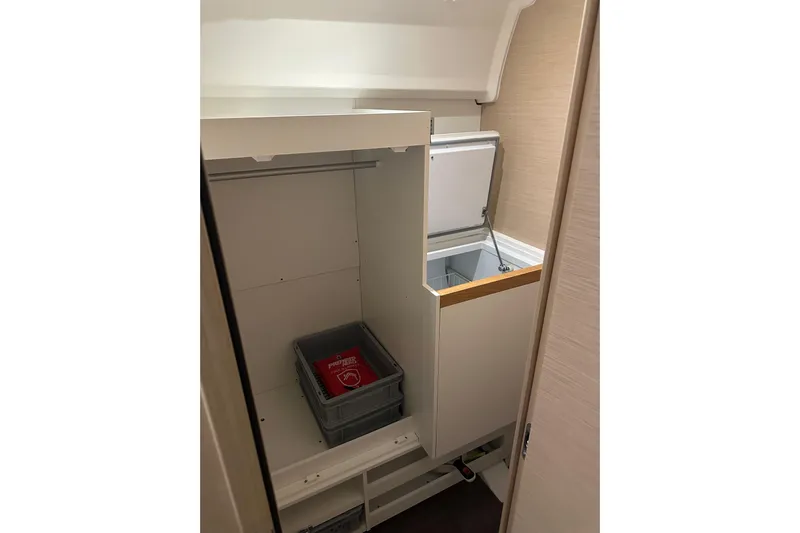 Recovery Room Yacht Photos Pics Interior storage space on a 2019 Jeanneau 51 yacht, featuring a closet and open compartment.