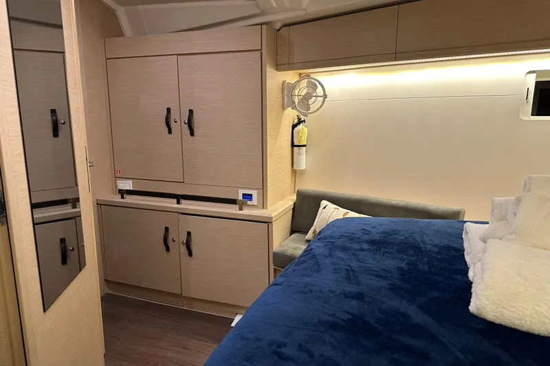Recovery Room Yacht Photos Pics Luxurious interior of 2019 Jeanneau 51 yacht with cozy bed and modern cabinetry.