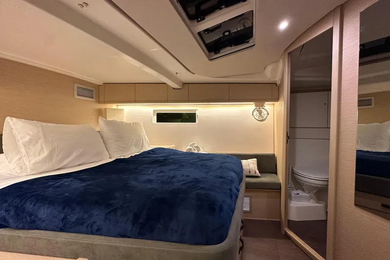 Recovery Room Yacht Photos Pics Luxurious interior cabin of 2019 Jeanneau 51 yacht with cozy bed and ensuite bathroom.