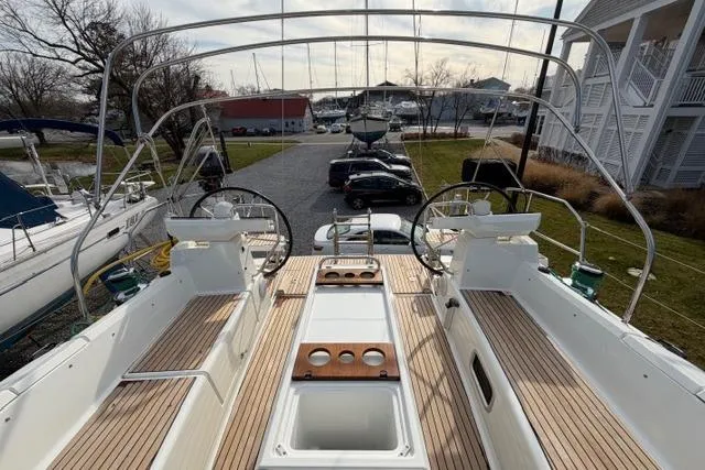 Recovery Room Yacht Photos Pics 2019 Jeanneau 51 yacht deck with dual steering wheels and wooden seating.