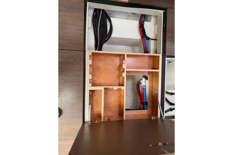 Recovery Room Yacht Photos Pics Interior view of 2019 Jeanneau 51 yacht showing wooden cabinetry and plumbing.