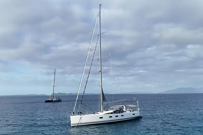 Miss Fiona Yacht Photos Pics 2020 Jeanneau 64 yacht sailing on calm ocean under cloudy sky.