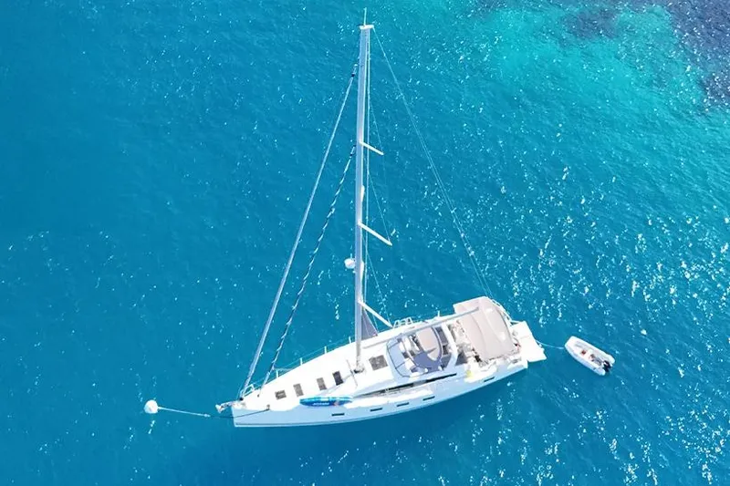 Miss Fiona Yacht Photos Pics Aerial view of 2020 Jeanneau 64 yacht on clear blue water.
