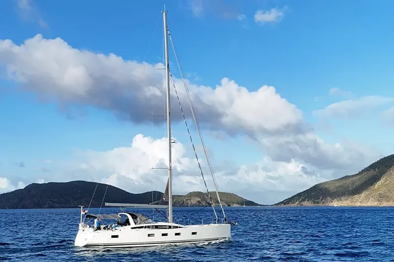 Miss Fiona Yacht Photos Pics 2020 Jeanneau 64 yacht sailing in clear blue waters with scenic island backdrop.