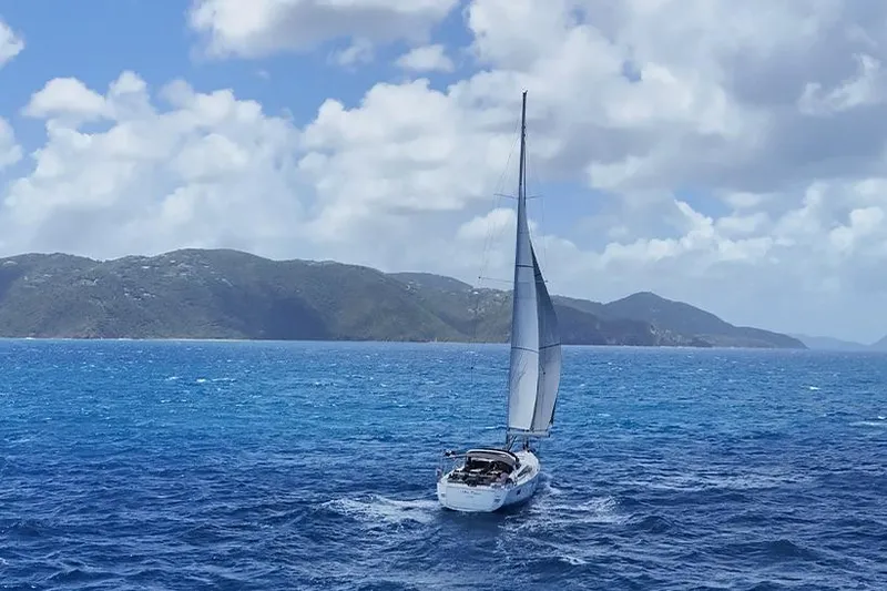 Miss Fiona Yacht Photos Pics Sailing yacht Jeanneau 64 (2020) on open sea with scenic mountain backdrop.