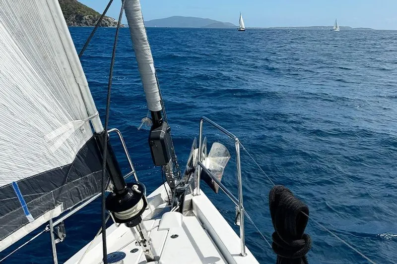 Miss Fiona Yacht Photos Pics Sailing on a 2020 Jeanneau 64 yacht in open blue sea with distant sailboats.