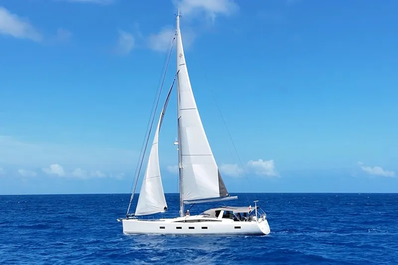 Miss Fiona Yacht Photos Pics 2020 Jeanneau 64 sailing yacht on open blue ocean under clear sky.