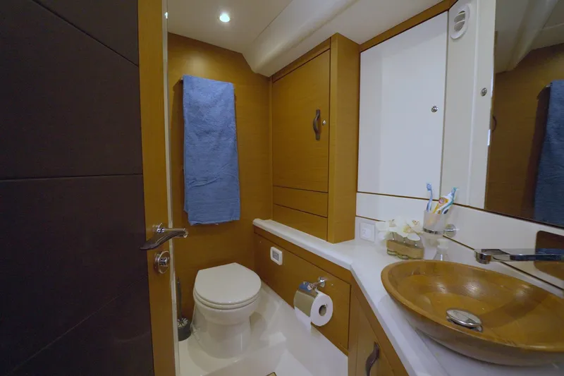 Miss Fiona Yacht Photos Pics Luxurious bathroom in 2020 Jeanneau 64 yacht with wooden sink and modern fixtures.