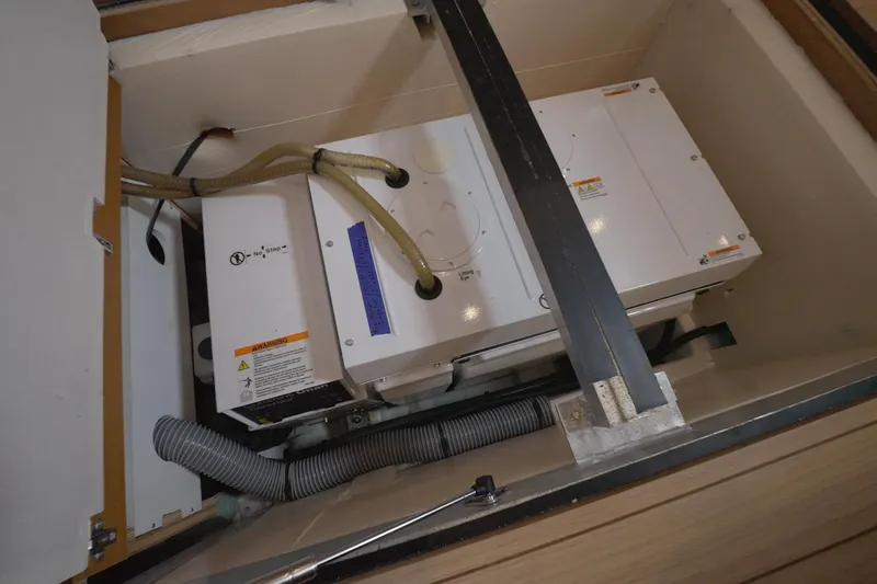 Miss Fiona Yacht Photos Pics Engine compartment of a 2020 Jeanneau 64 yacht, showcasing mechanical components and wiring.