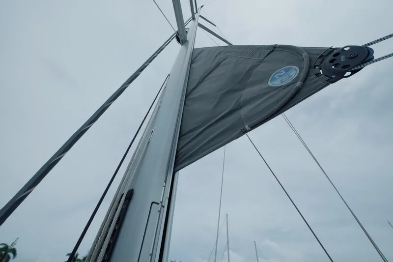 Miss Fiona Yacht Photos Pics 2020 Jeanneau 64 sailboat mast and sail against cloudy sky.