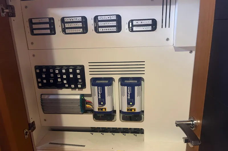 Miss Fiona Yacht Photos Pics Electrical panel inside a 2020 Jeanneau 64 yacht, featuring control switches and components.