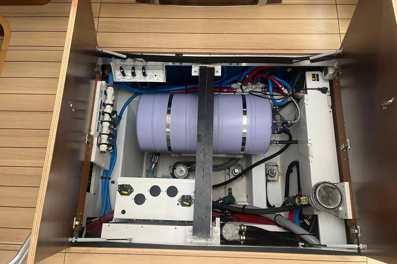Miss Fiona Yacht Photos Pics Engine compartment of a 2020 Jeanneau 64 yacht, showcasing mechanical components and wiring.