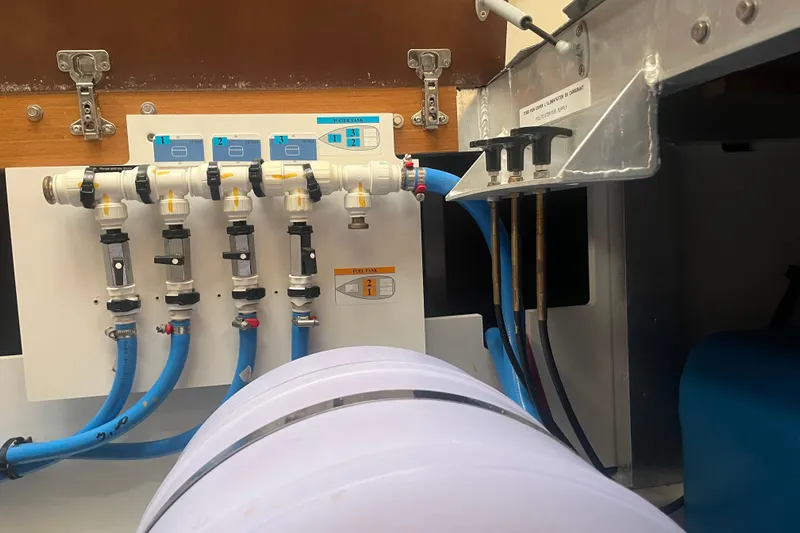 Miss Fiona Yacht Photos Pics Water system components in a 2020 Jeanneau 64 yacht, featuring pipes and valves.