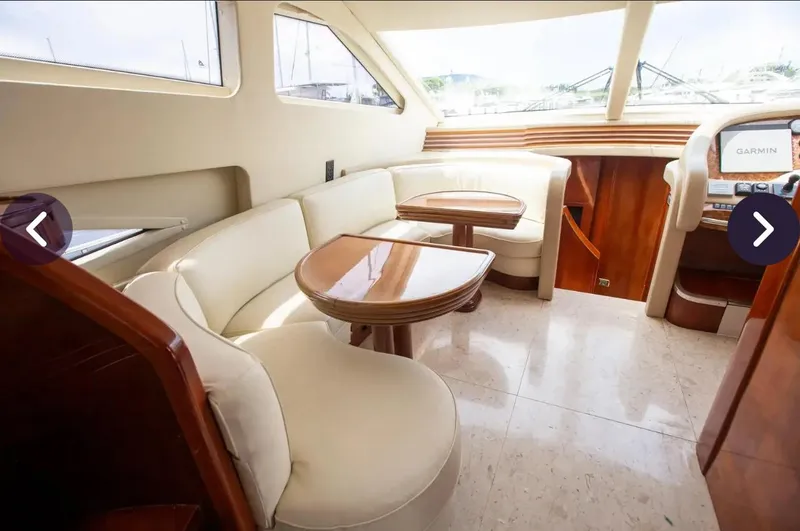  Yacht Photos Pics Luxurious interior of 2003 Azimut 74 Solar yacht with cream seating and wooden accents.