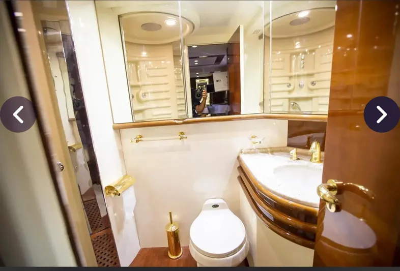  Yacht Photos Pics Luxurious bathroom in 2003 Azimut 74 Solar yacht with gold accents and elegant fixtures.